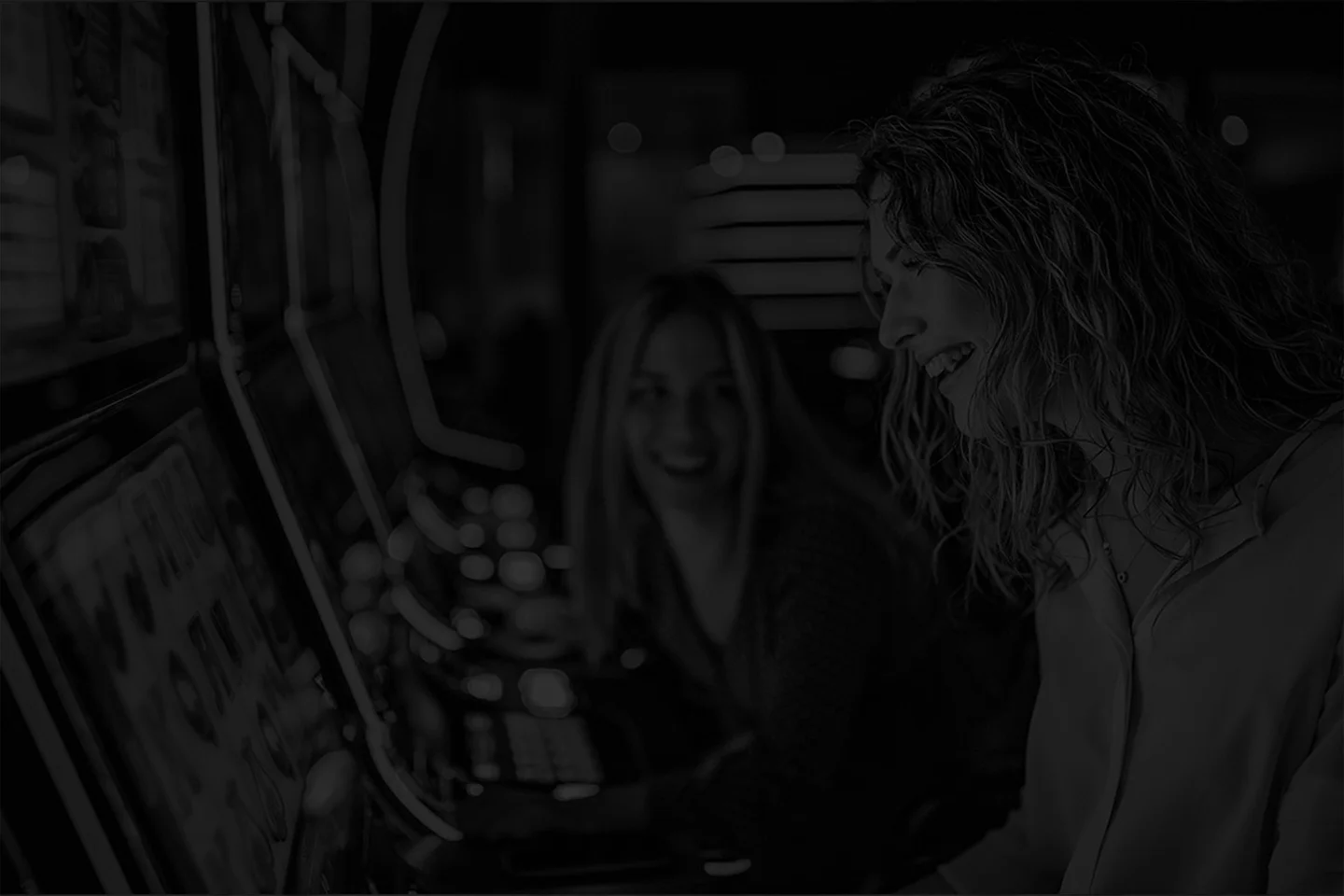 A couple of casino patrons responsibly enjoying a slot machine
