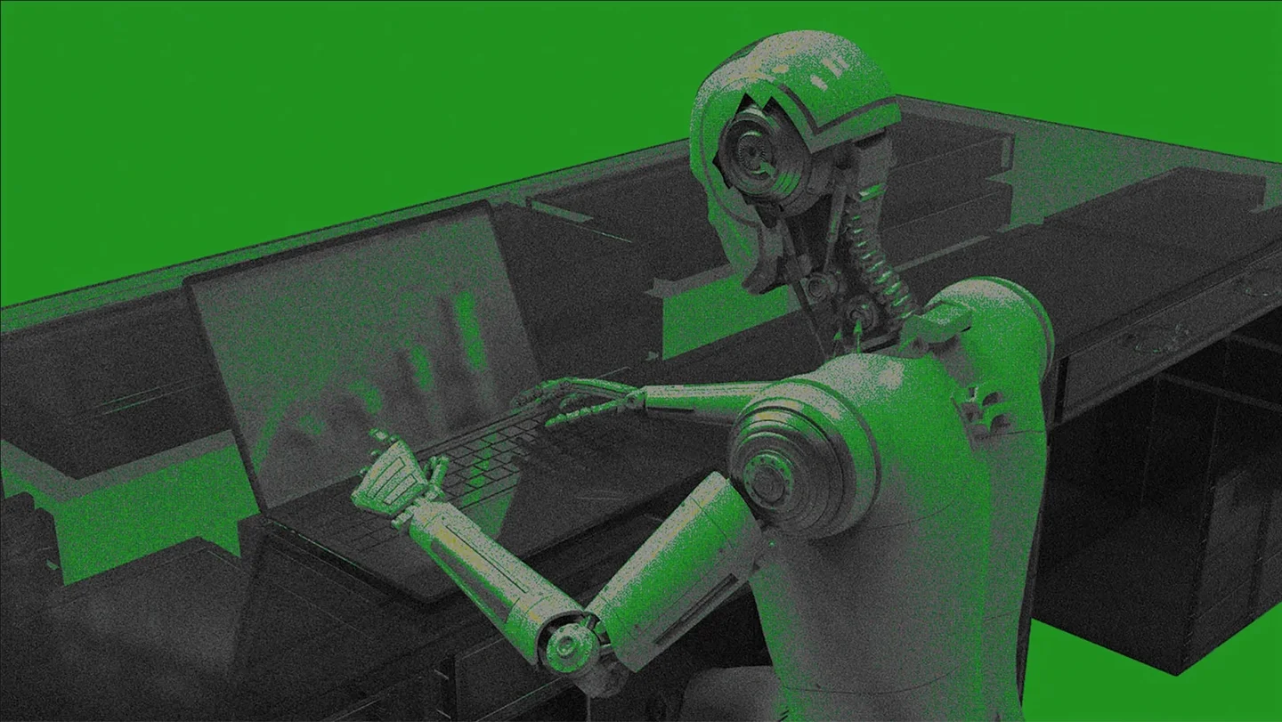 A humanoid sitting and operating a laptop computer