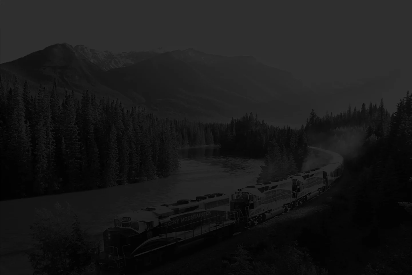  A Rocky Mountaineer luxury train moving alongside a river