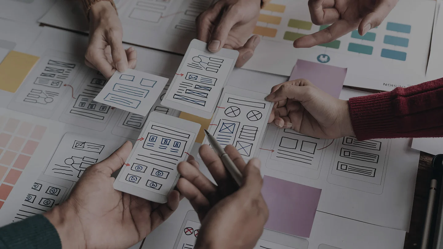 UX Designers using paper prototypes to help design a mobile app